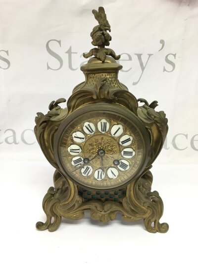 A French brass 8 day mantle clock with enamelled dial, approx height 30cm.