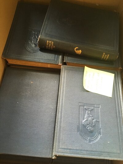 A box containing a collection of 20 volumes of The Punch Library Circa 1930's