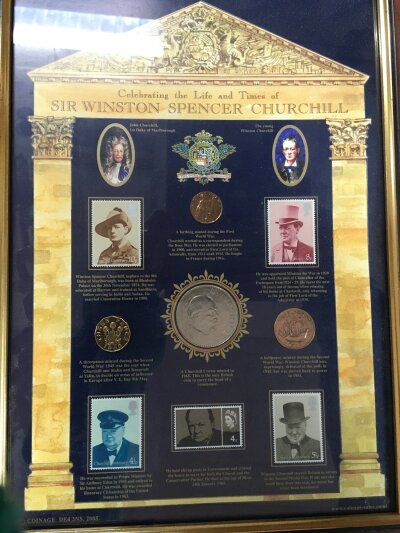 A box containing U.N and USA First Day Covers together with a framed Winston Churchill memorabilia