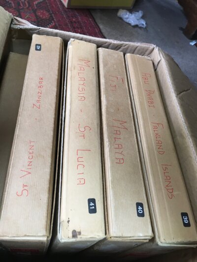 A box containing King George VI Crown albums plus 4 QEII New Age albums