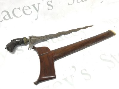 A Indonesian Kris with a carved hardwood handle. Blade 33cm long. 46cm total length