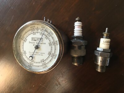 An Eliott speed indicator and two vintage spark plugs Champion C5 and Lodge- NO RESERVE
