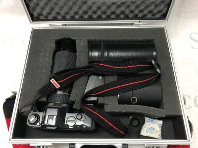 A cased Canon T50 camera with a Kiron 200mm lens , Clubman MC 28mm