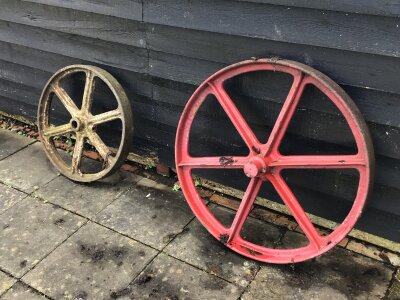 A Collection of Vintage Small holding farm equipment. Comprising sack barrows seed drills cast iron wheels.