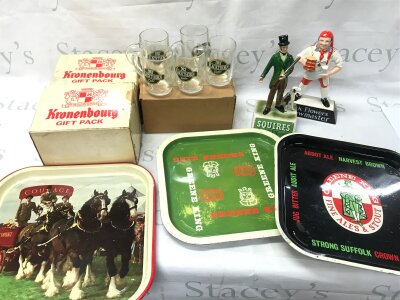 A Collection of vintage pub memorabilia and collectibles including trays courage, Greene king, Abbot ale , two Kronenbourg gift packs, Carlton wate pick flowers brewmaster figure and squires gin Charles E Tresise ceramic figure and a box full of vintage drinking glasses including Babycham and Guinness