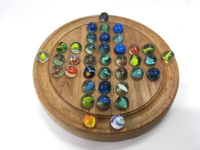 A solitaire board and marbles.