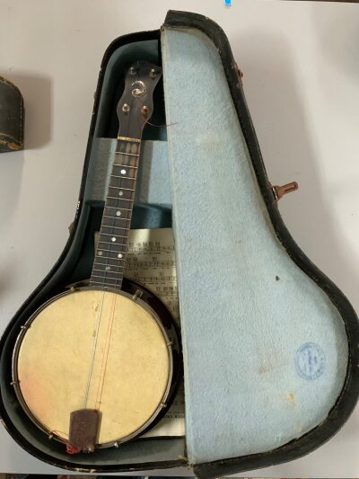 A vintage cased Whirlie banjo.