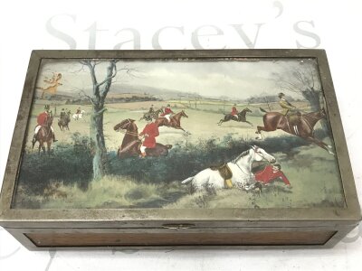 A Silver-plated cigar box featuring a hunting scene painting under glass on the lid. Dimensions 23.5cm wide, 7cm tall ,14cm deep