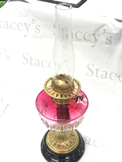 A Victorian cranberry oil lamp, 57cm tall