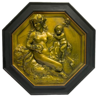 A 20th Century neoclassical style scene featuring a female satyr holding grapes and a young faun. Plaster composition gilt painted with black wooden frame. 54cm x 54cm