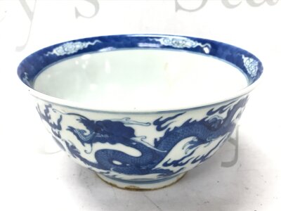 A Chinese blue and white dish featuring a fish and dragon chasing pearl motif, with a six character mark at base. 16cm wide 8cm tall