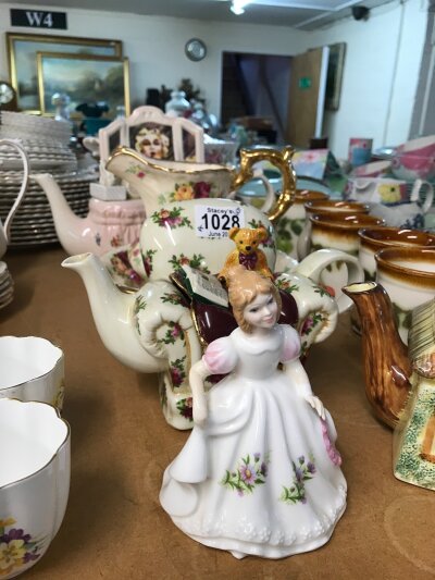 A Royal Albert country Roses decorative tea pot in the form of an armchair, together with a tea pot in the form of a dressing table and a Royal Doulton lady figure of the month September. Together with a jug and small bowl decorated with roses, one other teapot and Bilton mugs