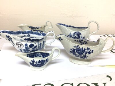 Four English porcelain sauce boats and a smaller jug possible cream jug all decorated with underglaze blue all unmarked. Minor chips and hairline cracks. (5)