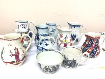 A Collection of 18th century English porcelain cream jugs some polychrome decorated in the mandarin style other blue and white jugs and a tea bowl and cup decorated with figures of the 18th century. Good condition some minor chips and hairline cracks (11)