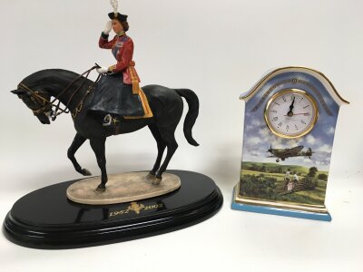 A limited edition trooping of the colour queen elizabeth II figure and a ceramic "heroes of the sky" mantle clock.