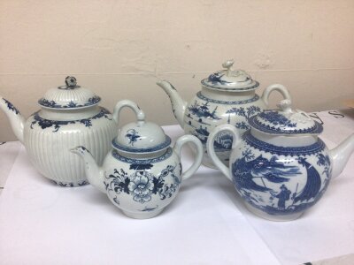 A Collection of four 18th century English porcelain tea pots decorated in the Chinese style some slight with two of the lids hairline see images the small canon shaped tea pot minor chip to the spout. (4)