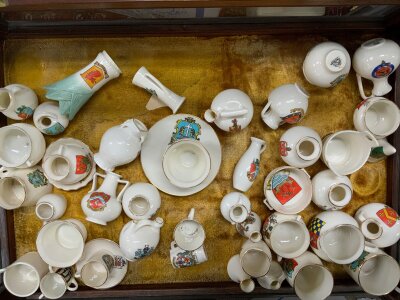A large collection of Goss crested china, including a pastel burner Goss Model of The Manx cottage.