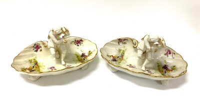 A pair of Royal Worcester porcelain Bon Bon dishes each with a seated musician, dual marks to Puce and green under glazed, with hand painted oriental pheasant scenes.