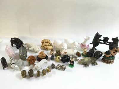 A collection of pig figures including ceramic and other