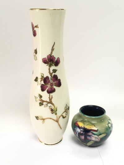 A small William Moorcroft orchid pattern vase, a/f, approx height 7cm together with a Zsolnay Pecs vase of waisted form, approx height 25cm, a Carltonware dish in the form of a leaf and an antique pot lid (4)