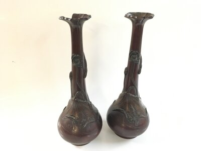 A pair of Japanese bronze vases, some damage, 29cm tall. Decorated with leaves and flowers.