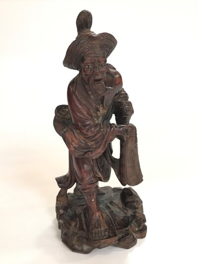 A carved hardwood sage figure. 26cm tall