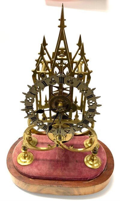 A 19thC skeleton clock with fusee movement, cathedral style. H. 16.5”