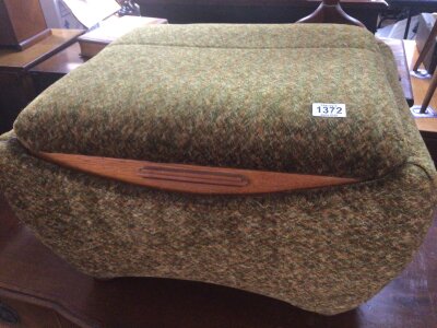 An Art Deco upholstered lounge box with an oak edge and hinged top.