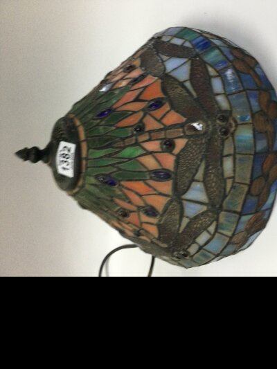 Tiffany-style stained glass lampshade, specifically the famous dragonfly pattern. Features dragonflies with detailed wings, sunset-toned upper panels, and blue water-like lower sections-closely following the classic Tiffany pattern. Made using the copper-foil method, with hand-cut art glass, coloured cabochon jewels, and leaded came work. It also comes with the bronze-finish metal base made to pair with the Tiffany style dragonfly lampshade.