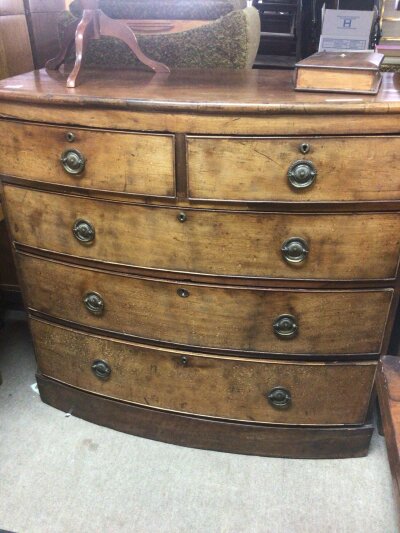An Early Victorian Mahogany bow fronted chest of drawers fitted with two short and three long drawers on a plinth base. Width 107cm x103cm