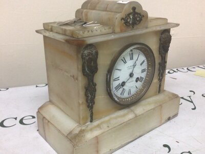 A late Victorian alabaster mantel clock fitted with a French movement gilt metal mounts the dial with retailers name J W Benson London. With key and pendulum.