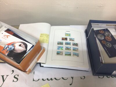 A Collection of unused Elizabeth III  Pictorial Alderney Mint Stamps including a stamp album. Including two boxes containing numerous presentation packs including high values. All very good condition.