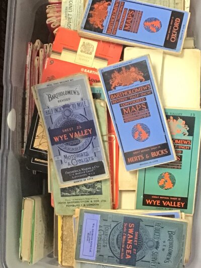A box containing Bartholomews Vintage folding maps for Motorists and cyclists and other vintage road maps British maps.