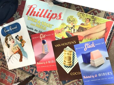 A Collection of vintage advertising posters including Phillips Stick a Soles, Van Houtens Cocoa, Bear Brand Superfine Stockings, Miners stick makeup etc