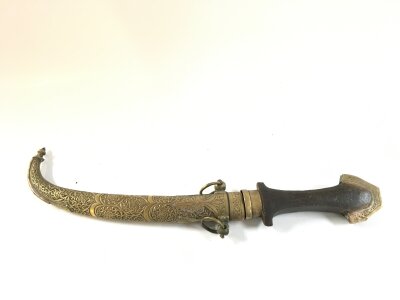 A North African Jambiya , brass scabbard, wooden handle. 39cm long