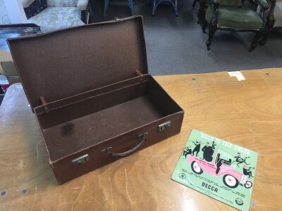 A small leather suitcase and vintage 10”  return to the delta record