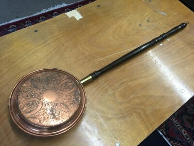 A Victorian warming pan with a very well engraved copper lid