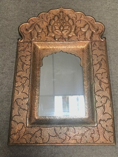 An antique copper wall mirror features elaborate hammered and pierced details in a traditional Indian Jalidar/ Jharokha style frame. Frame size 39cmx60cm