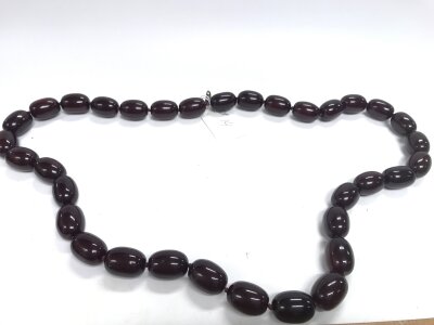 A large necklace in style of amber or Bakelite , not tested . 112cm, 335g