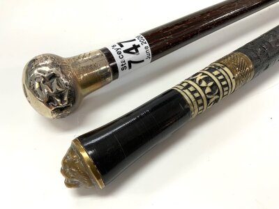 A carved Indian bone inlaid sword stick 57cm blade, together with a silver topped walking stick.