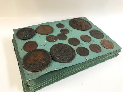 An interesting collection of Victorian bronze finished plaques of various historical seals, medals including full length figures of James the First, French uprising of 1799 etc