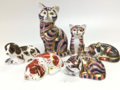 Six royal crown derby paperweights in the fork of cat and dog figures , all with stoppers . Three from the royal crown derby collectors guild