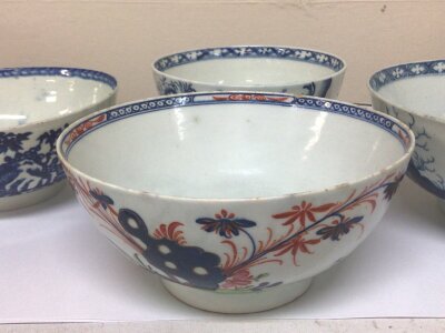 An 18th Century polychrome porcelain bowl circa 1770 Lowestoft diameter 16cm and three other 18th century English porcelain blue and white bowls decorated in the Chinese style no marks to the base very minor rim chips otherwise good condition in keeping with age (4)