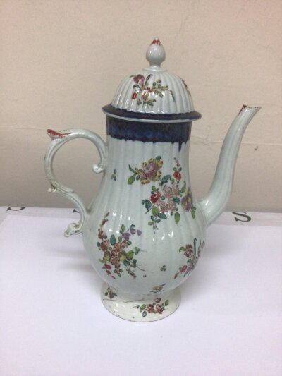 An 18th century circa 1775 porcelain coffee pot and cover most likely John Pennington Liverpool. hand painted with sprays of flowers with an under glazed deep blue edge hairline crack to the base. Height 27cm