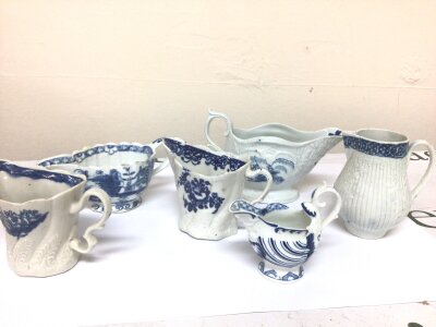 A collection of 18th English porcelain blue and white cream jugs bases without factory marks. With shaped rims and moulded decoration some hairline cracks minor chips. (6)