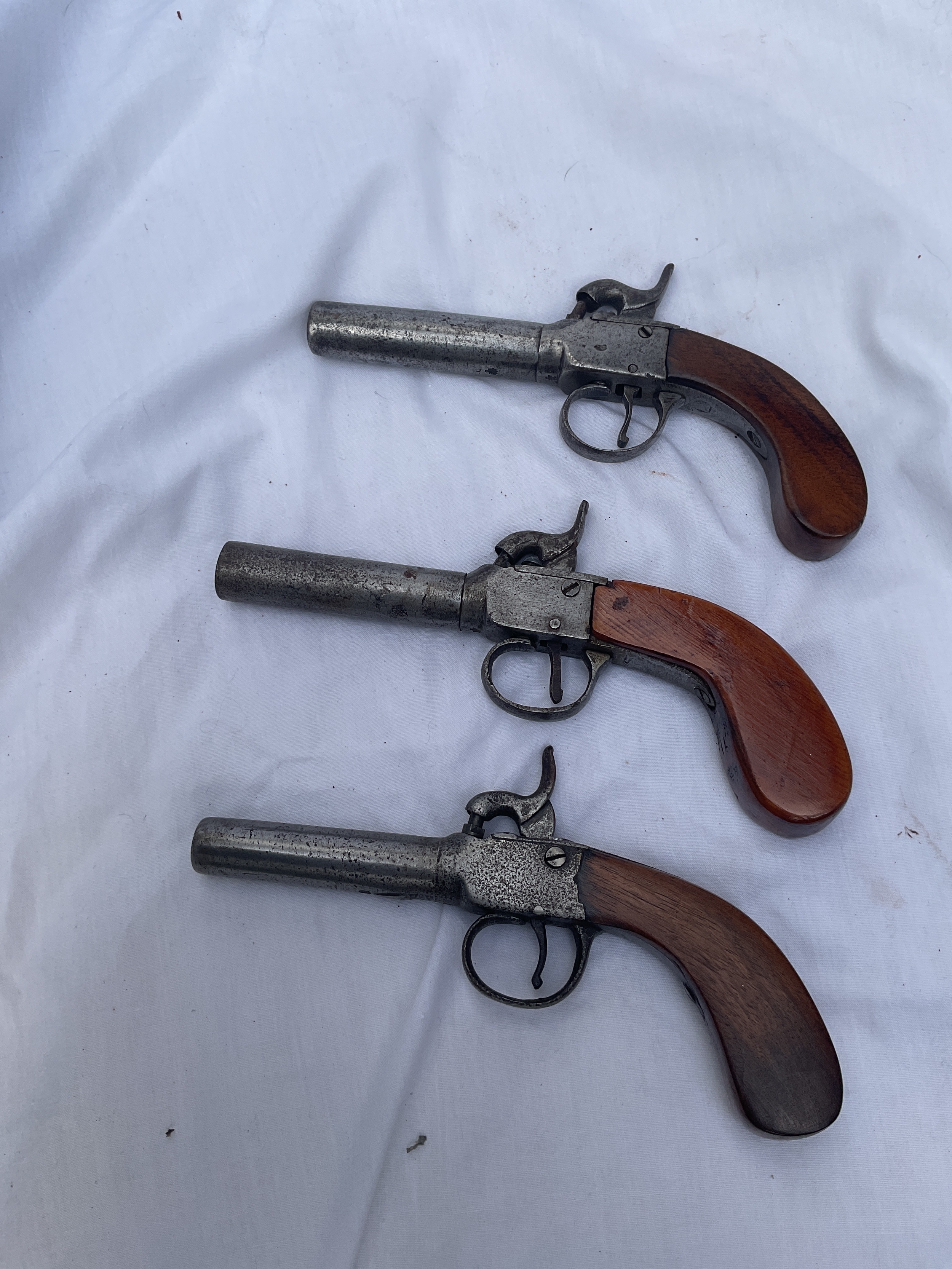 Three slab handled percussion pocket pistols C1880, all proof marked to under barrels.