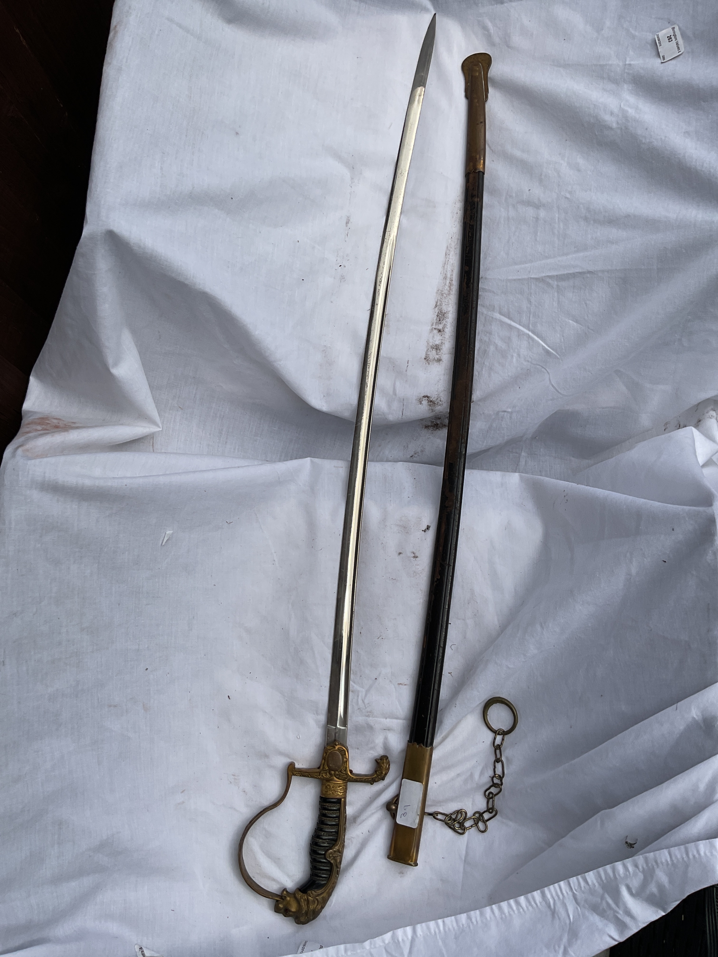 Prussian officers sword and sheath with coloured eyes to the grip.