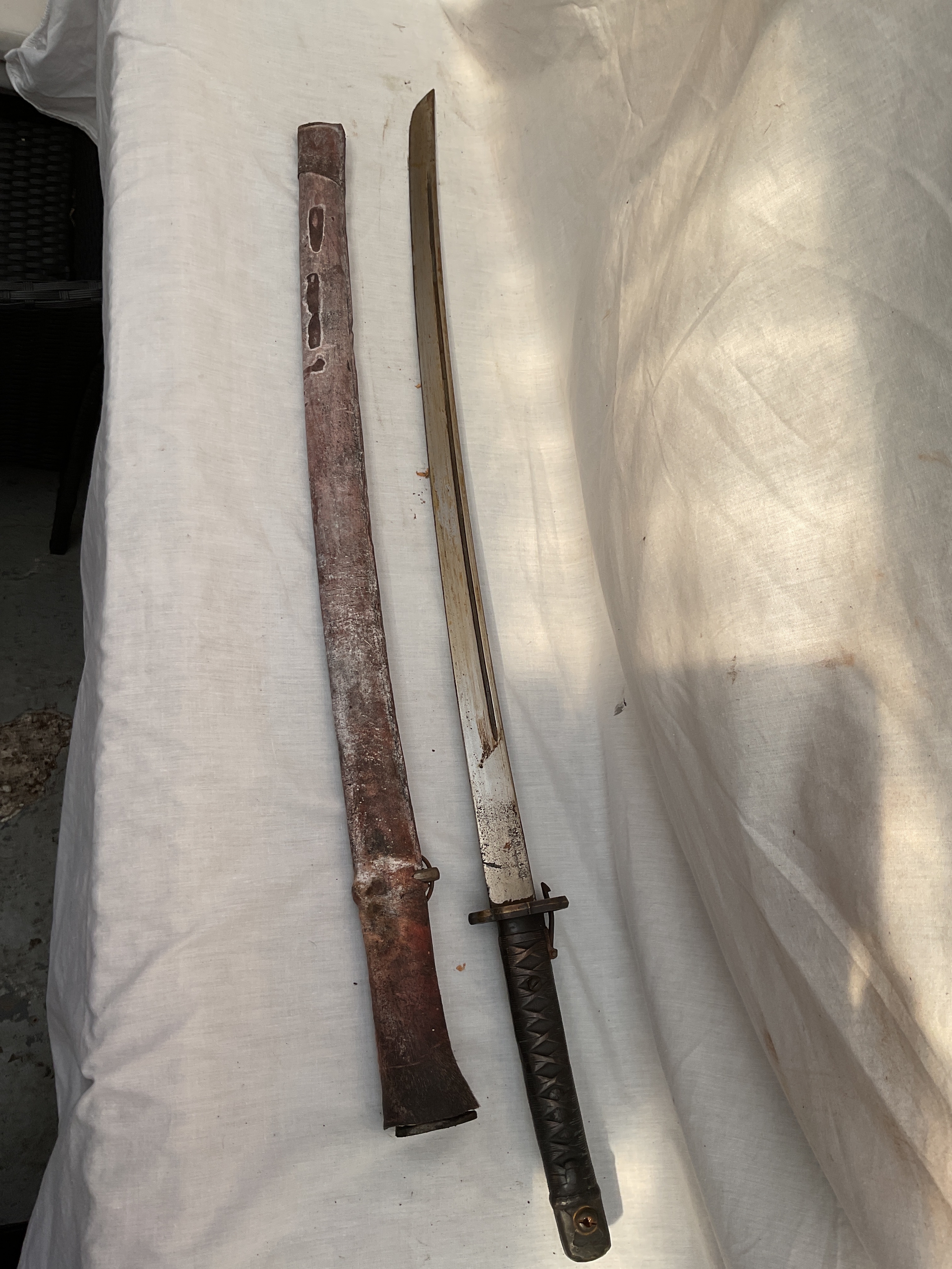 WWII Shin Gunto officers sword with marked blade and steel handle.and lock going through the Tsuba.