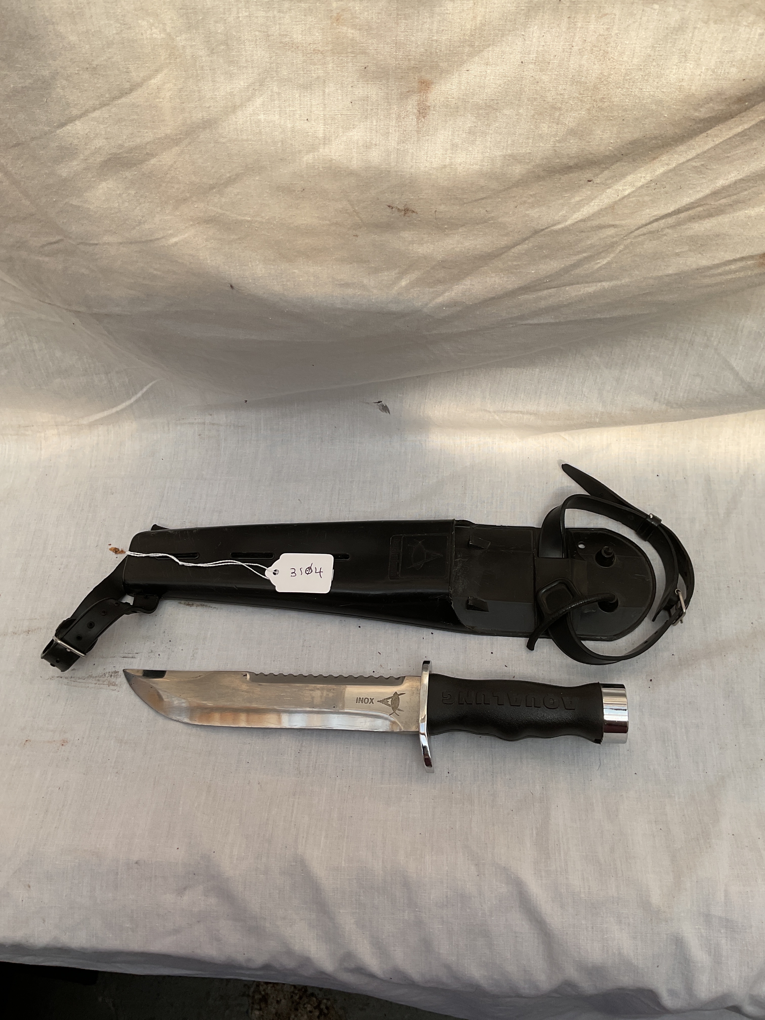 Aqualung divers knife and sheath.