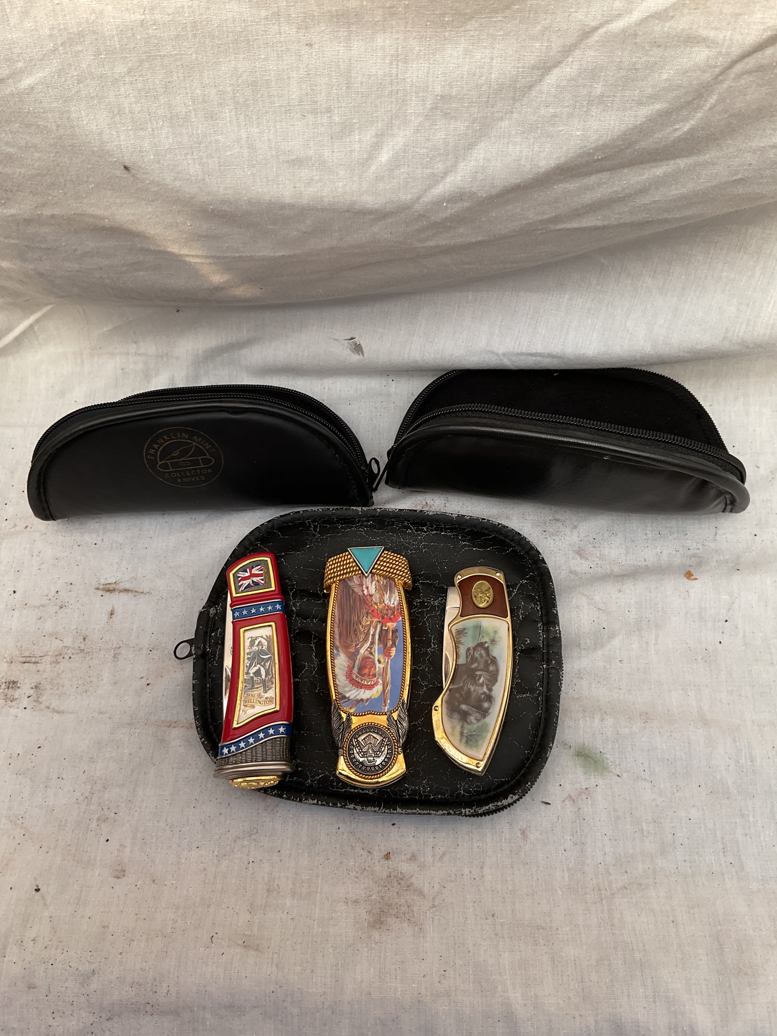 Three Franklin Mint ornate penknives and pouches.
